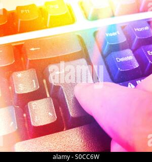 Finger pushing enter on keyboard Stock Photo