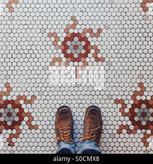 Tile floor and feet Stock Photo