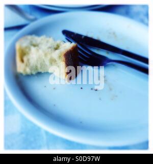 empty plate with fork, knife, bread and crumbs Stock Photo