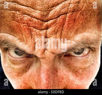 Middle aged man frowning Stock Photo