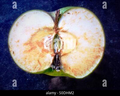 A cooking apple cut in half. Stock Photo