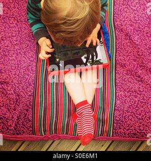 Young Boy playing on a Tablet Stock Photo