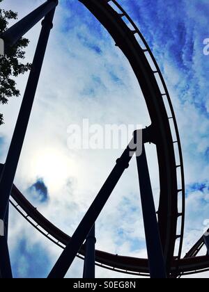 Silhouette of a roller coaster against a cloudy sky Stock Photo