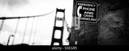 Emergency Phone and Crisis Counseling Sign on the Golden Gate Bridge. San Francisco, California, USA Stock Photo