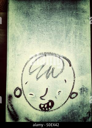Graffiti of a boy's Head in Berlin Stock Photo