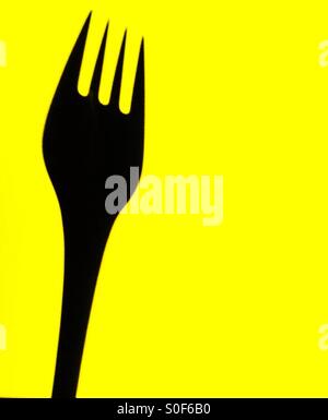 A fork on yellow background Stock Photo