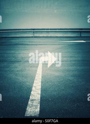 White painted arrow and exit marking on road outdoors Stock Photo - Alamy