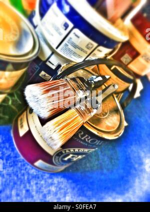 Paint brushes and tins of paint detail Stock Photo