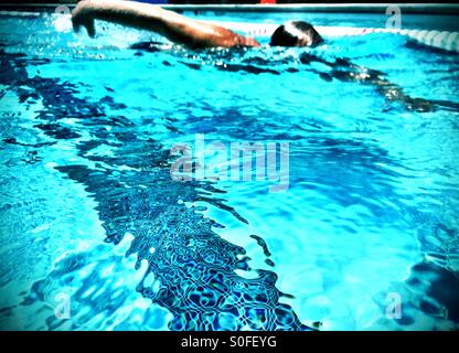 Competitive swimmer doing freestyle crawl, Australian crawl, outdoor swimming pool in San Francisco Bay Area. Stock Photo