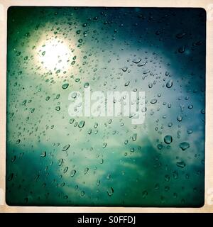 Sun and raindrops on Glass Window Stock Photo