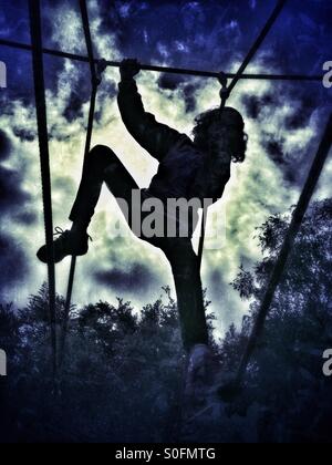 Girl on climbing frame Stock Photo