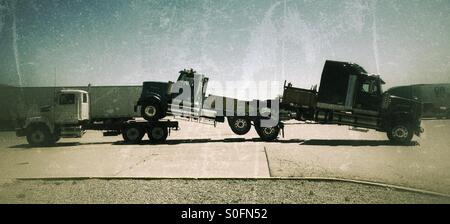 Semi Trucks new being towed to Dealers Stock Photo