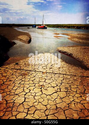 Dried mud at low tide. Blakeney, Norfolk, England. Stock Photo