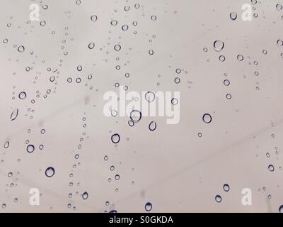 Water droplets on window on a rainy day Stock Photo