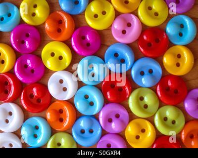 Colorful sewing buttons on a wooden table Stock Photo