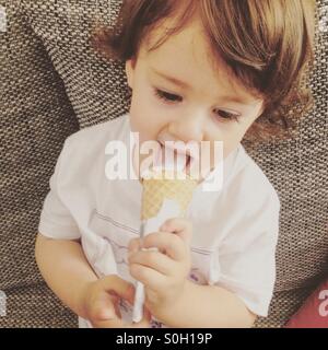 Small baby girl eating ice cream Stock Photo
