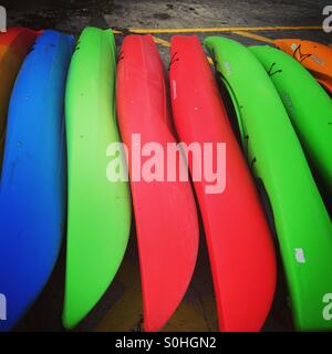 Row of colourful canoe boats lined up at a harbour in Dublin Ireland Stock Photo