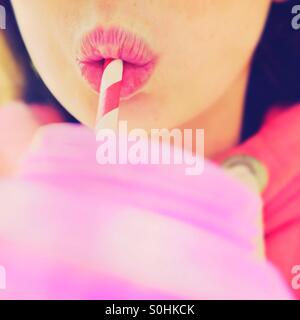 Young girl drinking with a straw Stock Photo