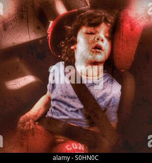 Child sleeping in car seat Stock Photo
