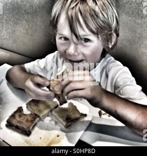 Five year old eating sandwich Stock Photo