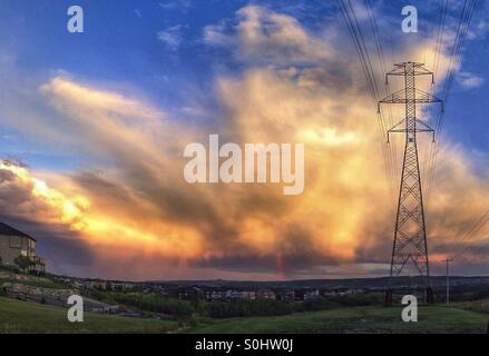 Panorama of a storm cloud over Calgary, at sunset, with rain band and rainbow. Alberta, Canada. Stock Photo
