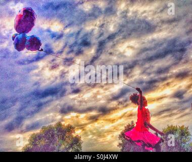 Young girl running with balloons Stock Photo