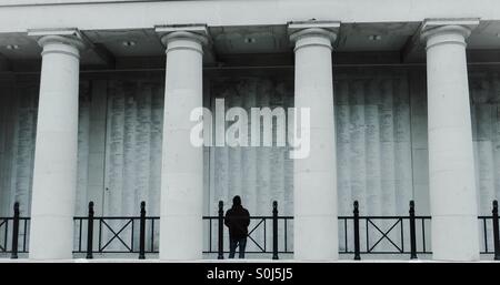 Man looking at the names on the Menin Gate Ypres Belgium Stock Photo