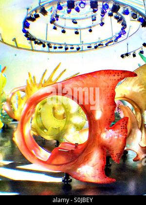 Brightly colored fiberglass fish ride at the Seaglass carousel in battery Park, NYC Stock Photo