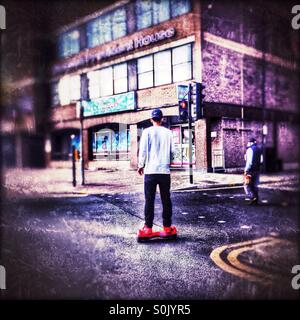 Man riding a dual wheel self balancing electric scooter, Harrow-on-the-hill, London Borough of Harrow, North West London, England, United Kingdom, Europe Stock Photo