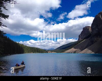 People on Moraine lake in a canoe in Alberta Canada Stock Photo