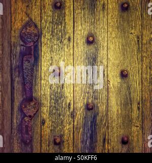 Medieval castle door with rusty handle and iron studs. Portencross, Scotland Stock Photo