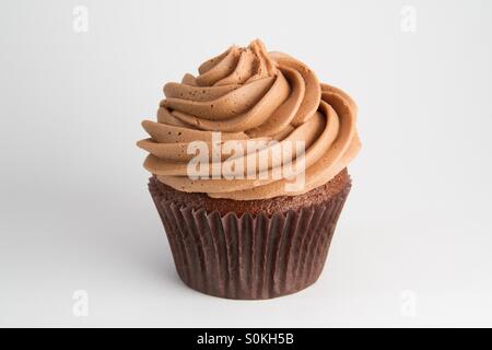 A chocolate cupcake on a white background. Stock Photo