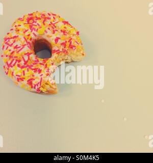 Ring doughnut with bite taken out of it Stock Photo