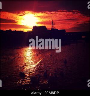 Gravesend town pier at Gravesend Kent at sunset with the docks at ...