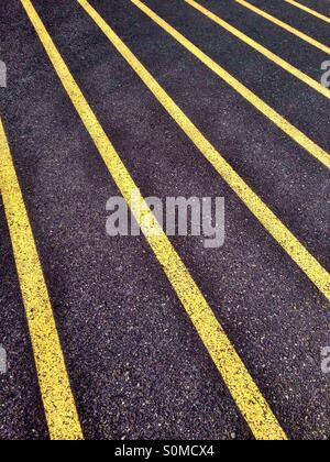 Yellow lines on athletic running track Stock Photo