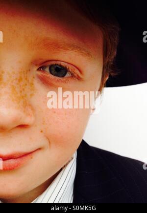 Freckles on the face of a red haired 10-year old boy Stock Photo