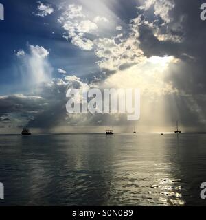 Sun beams shine down on the sea. Stock Photo