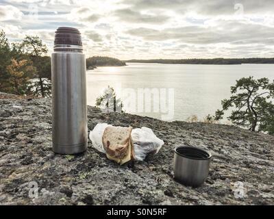 https://l450v.alamy.com/450v/s0n5rf/a-thermos-flask-a-sandwich-and-a-cup-of-coffee-against-the-backdrop-s0n5rf.jpg