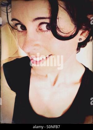 Woman with dark brown eyes and hair smiling Stock Photo