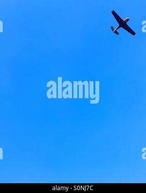 Minimalist plane on blue sky Stock Photo