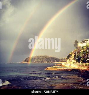 Double rainbow over beach Stock Photo