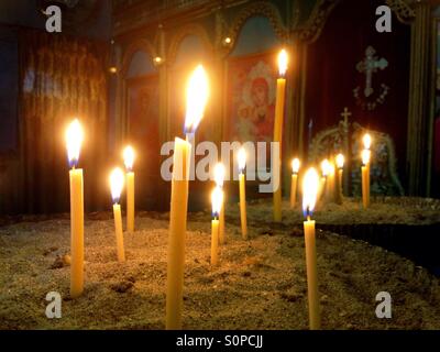 Lit candles in Bulgarian monastery Stock Photo