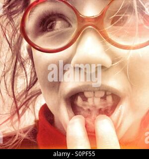 Little girl showing missing teeth Stock Photo