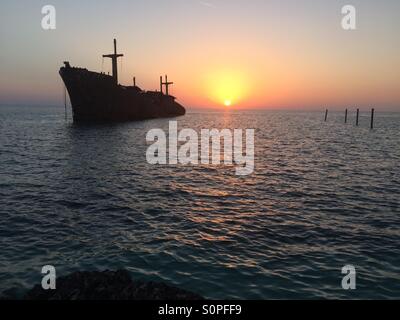 Greek ship wreckage at sunset in kish island Stock Photo