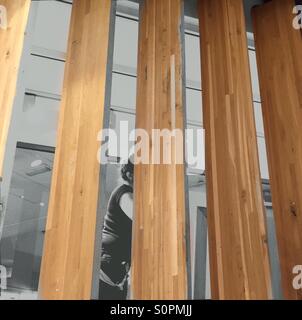 Person behind vertical blinds decoration of a shop showroom. Stock Photo
