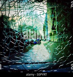Broken Glass and a city street in the background Stock Photo