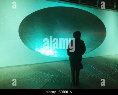 Woman and 'Sonic Dish', Tilikum Crossing Bridge, Portland, Oregon, illuminated at night Stock Photo