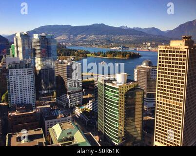 Aerial view of downtown Vancouver, Stanley Park, Burrard Inlet and Mountains. Stock Photo