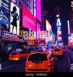 Times Square New York at night with yellow cabs. Stock Photo