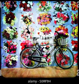 Bicycle with floral wallpaper art installation Stock Photo